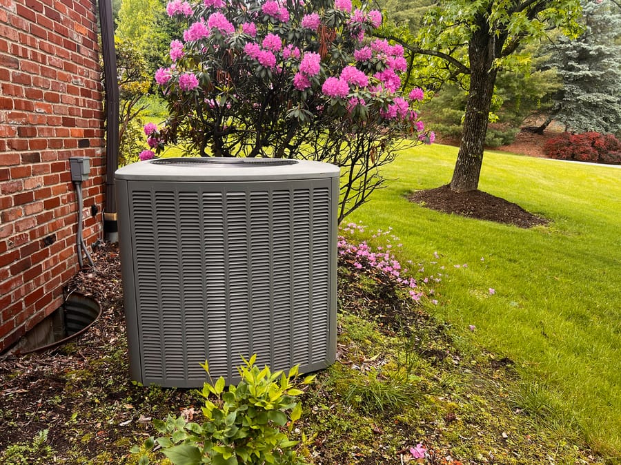 Air conditioning unit sitting outside house.