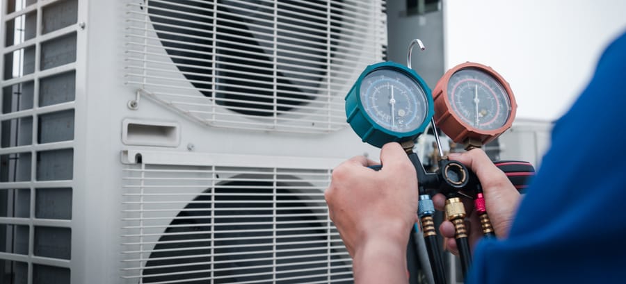 Technician is checking air conditioner,measuring equipment.